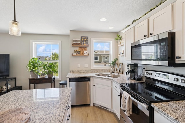 247 Red Oak Ct, Norwalk, IA 50211 - kitchen with appliances with stainless steel finishes, open shelves, a sink, white cabinetry, and a textured ceiling