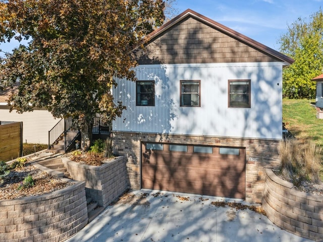 1314 Glenway Dr, Newton, IA 50208 - view of property exterior featuring a garage, concrete driveway, and stone siding