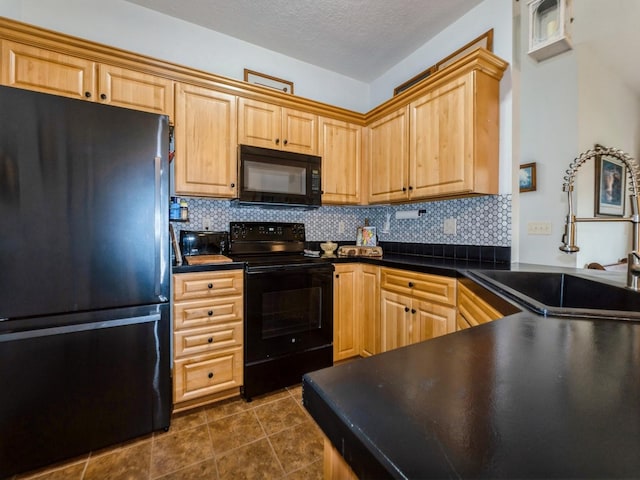 528 Kelsey Ln, Altoona, IA 50009 - kitchen featuring black appliances, a sink, decorative backsplash, dark countertops, and dark tile patterned floors