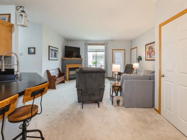 528 Kelsey Ln, Altoona, IA 50009 - carpeted living area with a sink and a glass covered fireplace