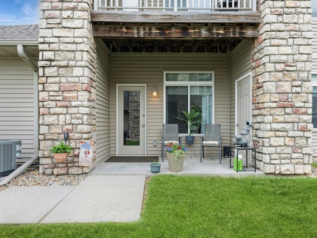 528 Kelsey Ln, Altoona, IA 50009 - property entrance with a balcony, central air condition unit, and a lawn