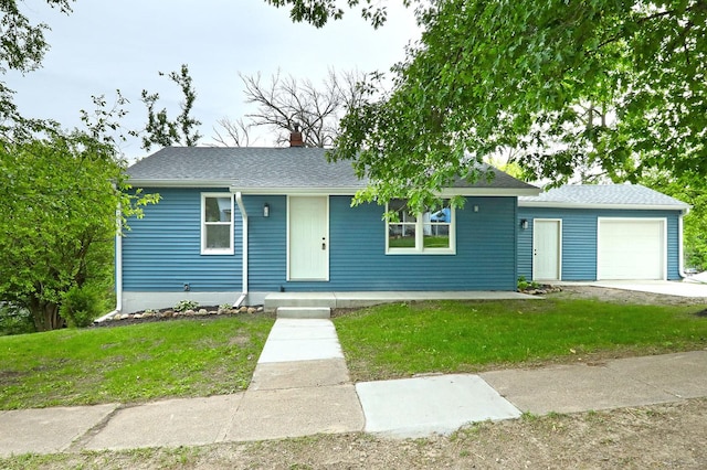 314 E Front St, Colfax, IA 50054 - view of front of house featuring a front lawn, a chimney, an attached garage, and roof with shingles