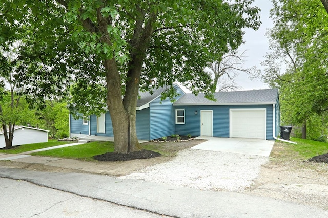 314 E Front St, Colfax, IA 50054 - view of front of house featuring an attached garage, driveway, and a shingled roof