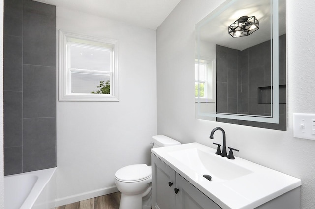314 E Front St, Colfax, IA 50054 - bathroom featuring vanity, wood finished floors, and toilet