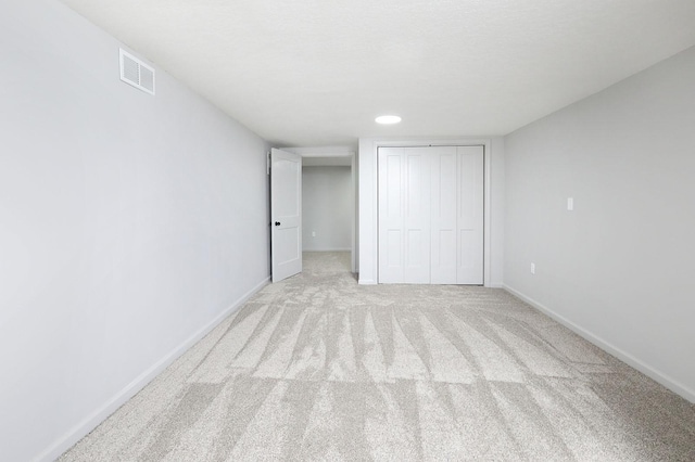 314 E Front St, Colfax, IA 50054 - unfurnished bedroom featuring a closet, light carpet, and baseboards