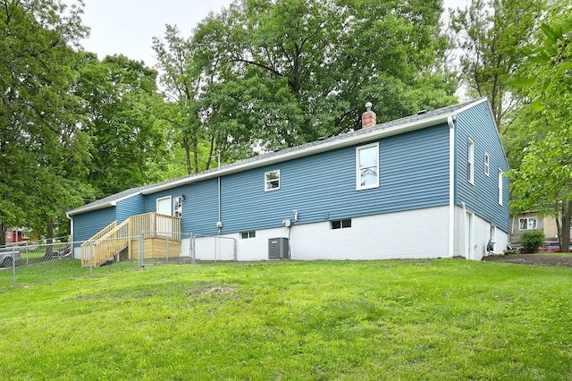 314 E Front St, Colfax, IA 50054 - rear view of property with a chimney, view of scattered trees, and central air condition unit
