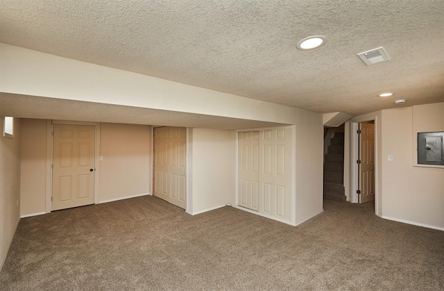 2112 E 23rd St, Des Moines, IA 50317 - finished basement with a textured ceiling, carpet flooring, stairs, recessed lighting, and baseboards