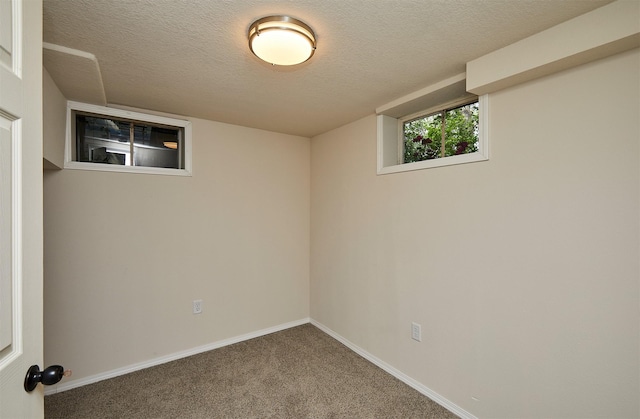 2112 E 23rd St, Des Moines, IA 50317 - basement with carpet, a textured ceiling, and baseboards