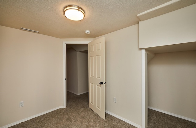 2112 E 23rd St, Des Moines, IA 50317 - unfurnished bedroom with carpet flooring, baseboards, and a textured ceiling