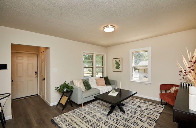 2112 E 23rd St, Des Moines, IA 50317 - living room with dark wood-style flooring, plenty of natural light, baseboards, and a textured ceiling