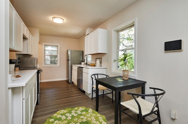 2112 E 23rd St, Des Moines, IA 50317 - kitchen featuring stainless steel appliances, light countertops, dark wood finished floors, and healthy amount of natural light