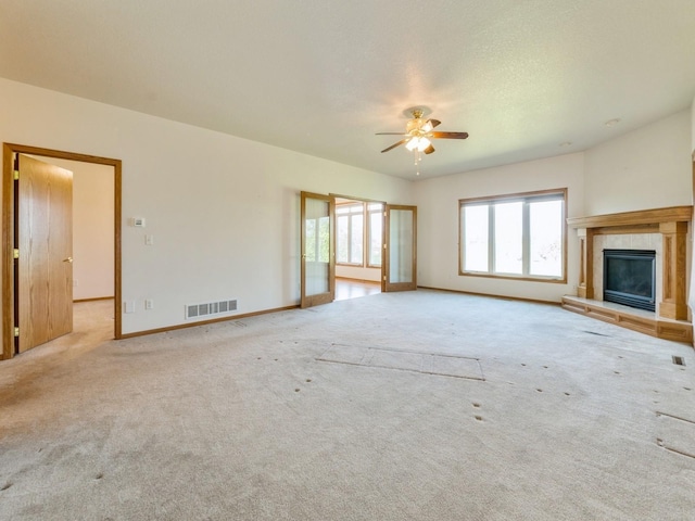 2117 W 4th Ave, Indianola, IA 50125 - unfurnished living room with a ceiling fan, a fireplace, carpet flooring, and baseboards