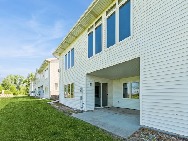 2117 W 4th Ave, Indianola, IA 50125 - rear view of property featuring a yard and a patio area