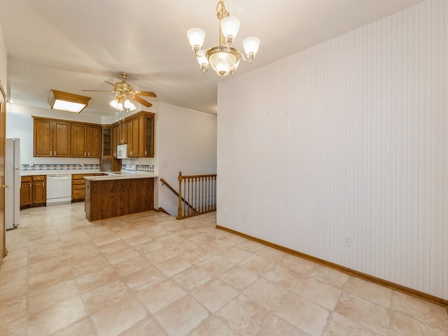 2117 W 4th Ave, Indianola, IA 50125 - kitchen with white appliances, brown cabinetry, ceiling fan, glass insert cabinets, and a peninsula