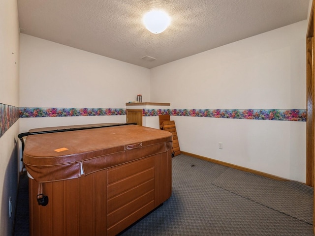 2117 W 4th Ave, Indianola, IA 50125 - carpeted bedroom featuring a textured ceiling and baseboards