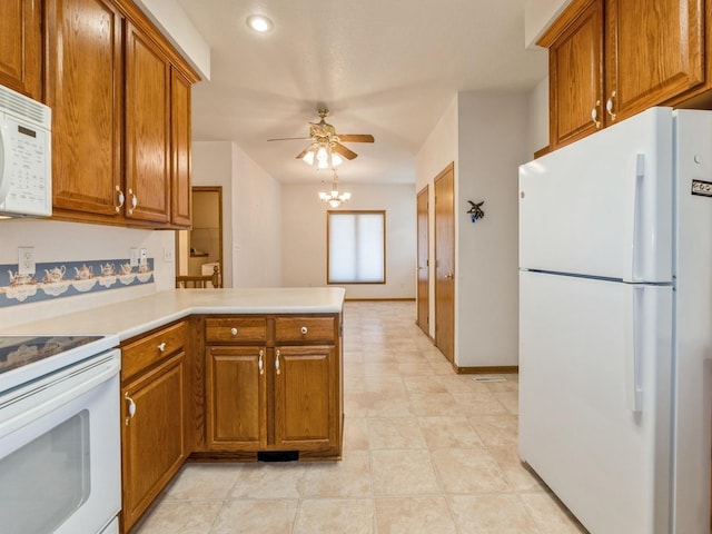 2117 W 4th Ave, Indianola, IA 50125 - kitchen featuring white appliances, brown cabinetry, a ceiling fan, a peninsula, and light countertops