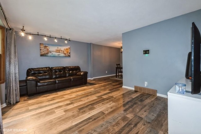 4305 65th St, Urbandale, IA 50322 - living area featuring wood finished floors, baseboards, and track lighting