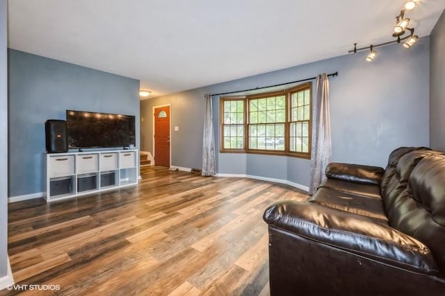 4305 65th St, Urbandale, IA 50322 - living area featuring wood finished floors, baseboards, and rail lighting