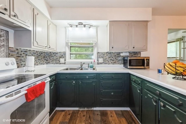 4305 65th St, Urbandale, IA 50322 - kitchen with electric stove, stainless steel microwave, a sink, decorative backsplash, and light countertops