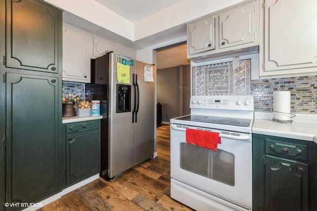 4305 65th St, Urbandale, IA 50322 - kitchen with white electric range, stainless steel fridge, dark wood-style floors, light countertops, and decorative backsplash
