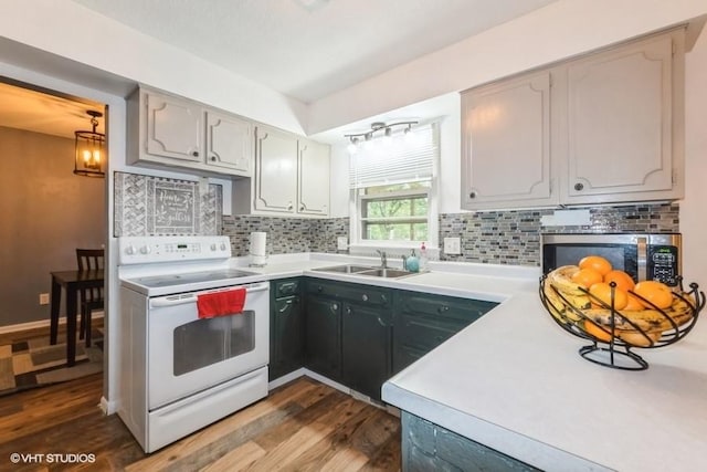 4305 65th St, Urbandale, IA 50322 - kitchen featuring electric stove, a sink, dark wood finished floors, and backsplash