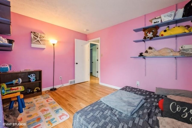 4305 65th St, Urbandale, IA 50322 - bedroom with wood finished floors and baseboards