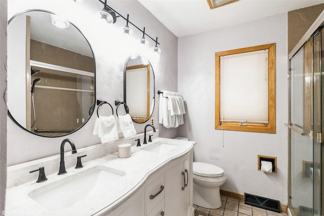 529 NW State St, Ankeny, IA 50023 - bathroom with tile patterned floors, a stall shower, double vanity, and toilet