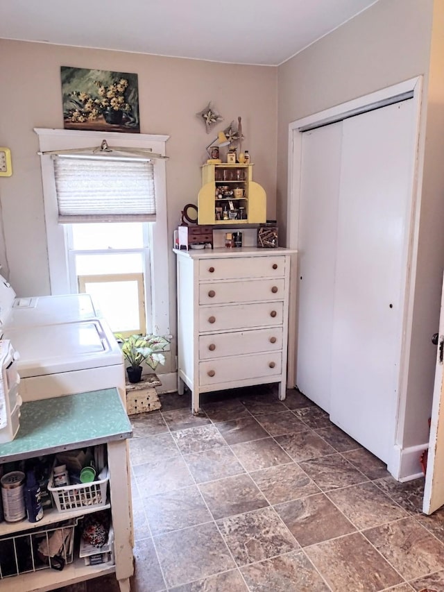 318 W Green St, Winterset, IA 50273 - bedroom with washer and clothes dryer, stone finish floors, and a closet