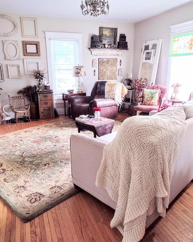 318 W Green St, Winterset, IA 50273 - living room with hardwood / wood-style floors and a chandelier