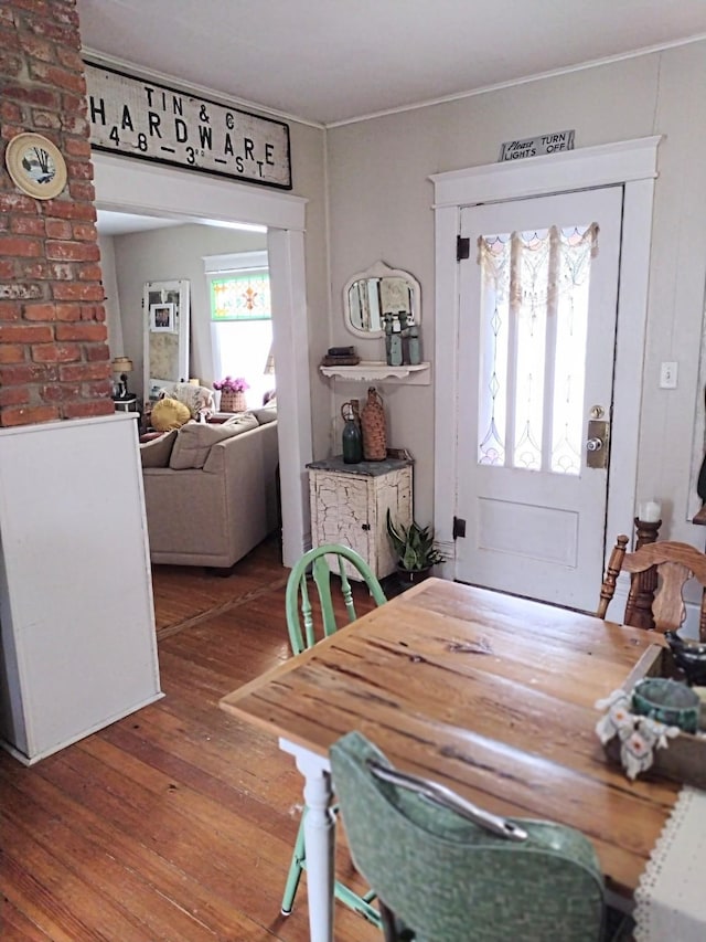 318 W Green St, Winterset, IA 50273 - dining space with wood-type flooring and ornamental molding