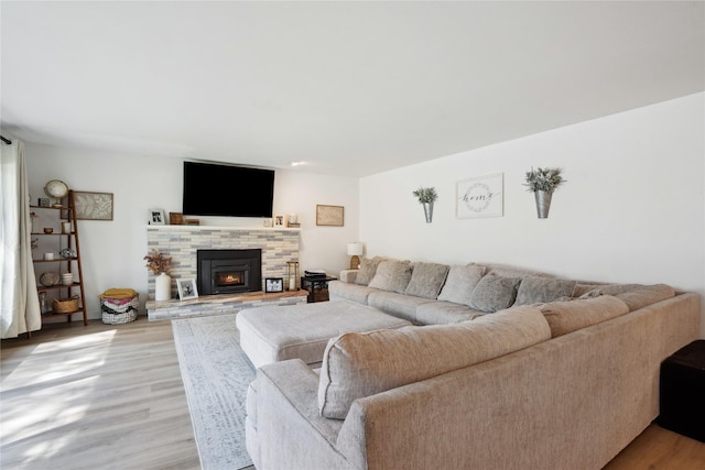 743 15th St, Nevada, IA 50201 - living area featuring light wood-type flooring and a stone fireplace