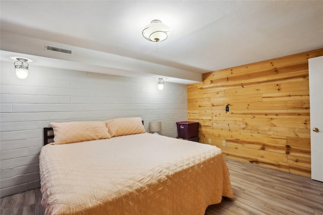 743 15th St, Nevada, IA 50201 - bedroom featuring wood finished floors and concrete block wall