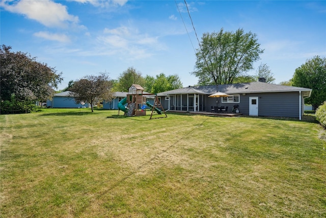 743 15th St, Nevada, IA 50201 - view of green lawn featuring a playground and a sunroom