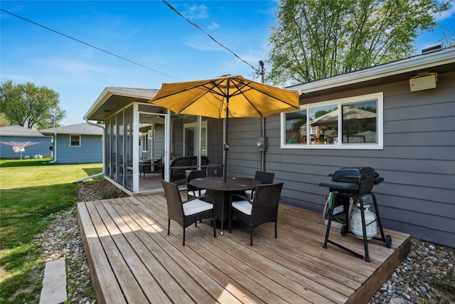 743 15th St, Nevada, IA 50201 - wooden terrace with a sunroom, a lawn, outdoor dining space, and area for grilling