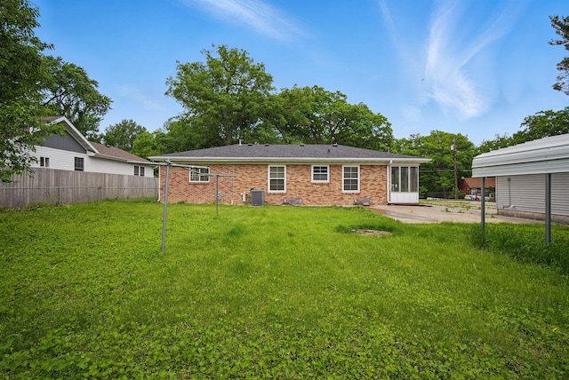 2620 Arnold Rd, Des Moines, IA 50310 - rear view of property featuring cooling unit, a patio area, and brick siding