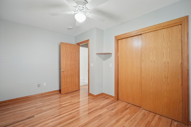 2620 Arnold Rd, Des Moines, IA 50310 - unfurnished bedroom with a closet, light wood-style flooring, a ceiling fan, and baseboards