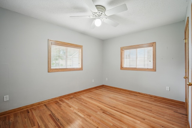 2620 Arnold Rd, Des Moines, IA 50310 - empty room featuring wood finished floors, ceiling fan, baseboards, and a textured ceiling