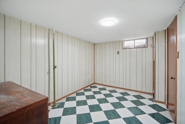 2620 Arnold Rd, Des Moines, IA 50310 - basement featuring tile patterned floors, wood walls, and baseboards