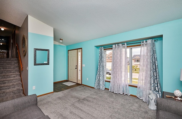 4230 SE 23rd St, Des Moines, IA 50320 - unfurnished living room featuring stairway, carpet floors, baseboards, and a textured ceiling