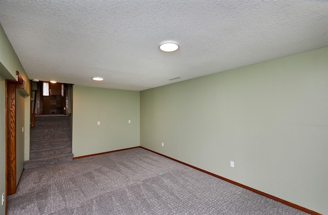 4230 SE 23rd St, Des Moines, IA 50320 - spare room with carpet floors, baseboards, stairs, and a textured ceiling