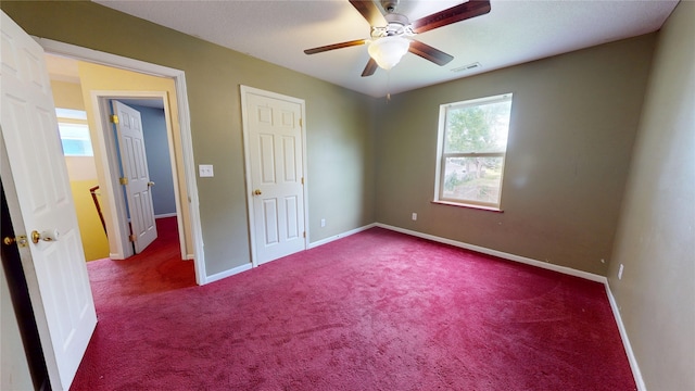1534 18th St, Des Moines, IA 50314 - unfurnished bedroom featuring carpet, baseboards, and a ceiling fan