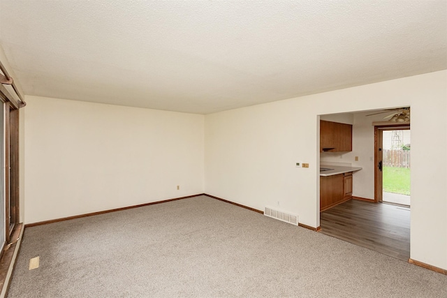 7405 Aurora Ave, Urbandale, IA 50322 - unfurnished living room with dark carpet and baseboards