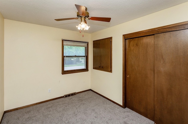7405 Aurora Ave, Urbandale, IA 50322 - unfurnished bedroom with carpet floors, baseboards, ceiling fan, and a closet