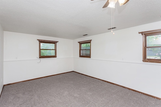 7405 Aurora Ave, Urbandale, IA 50322 - carpeted spare room featuring a textured ceiling, ceiling fan, and baseboards