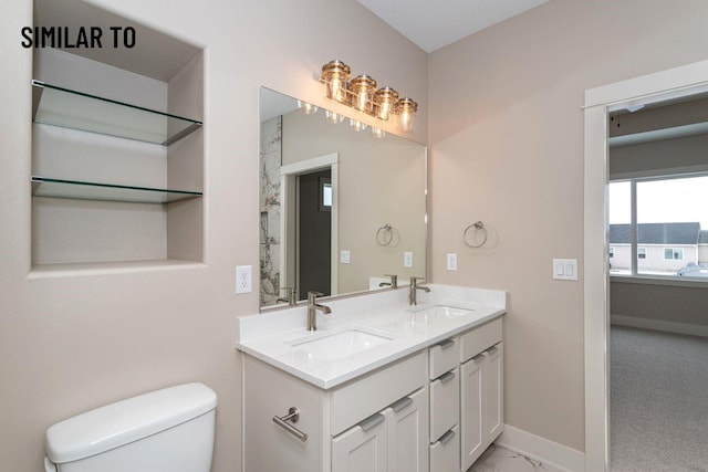 532 Wicker Dr, Huxley, IA 50124 - full bath featuring toilet, double vanity, baseboards, and marble look tiles