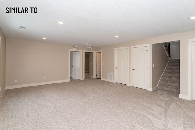 532 Wicker Dr, Huxley, IA 50124 - below grade area with stairway, carpet, baseboards, and recessed lighting