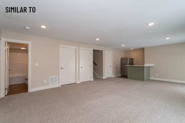 532 Wicker Dr, Huxley, IA 50124 - unfurnished living room featuring light carpet, baseboards, recessed lighting, and stairs