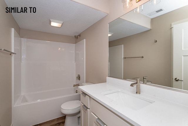 532 Wicker Dr, Huxley, IA 50124 - full bathroom with toilet, vanity, bathing tub / shower combination, a textured ceiling, and wood finished floors