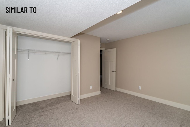 532 Wicker Dr, Huxley, IA 50124 - unfurnished bedroom featuring carpet flooring, a closet, baseboards, and a textured ceiling