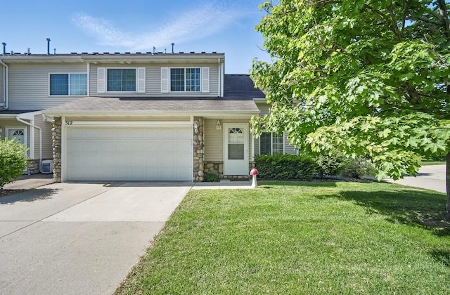 3799 Village Run Dr Unit 512, Des Moines, IA 50317 - view of front of home with a front yard, driveway, and stone siding